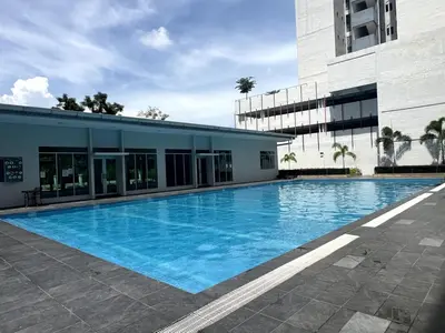 a large swimming pool in front of a building at Relaxstay Anderson Residences, Family Friendly 6px 2br in Ipoh