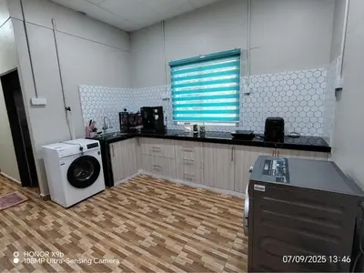 a kitchen with a washing machine and a washer at Homestay Haji Omar Sungai Dua Butterworth in Kampong Lahar Yooi