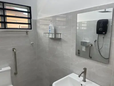 a bathroom with a toilet and a sink and a mirror at Free EV Car Charge KTV Snooker&PS5Game 13Pax Ipoh in Ipoh