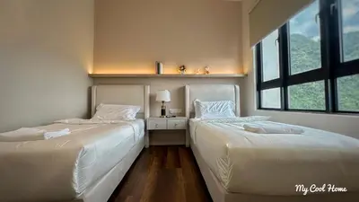 two beds sitting next to each other in a bedroom at Onsen Suite Theme Park View in Ipoh