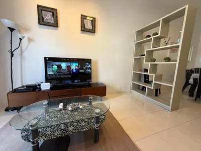 a living room with a tv and a glass table at AYAAN Highland Escape with PS4 gaming and Netflix at Cameron Highland in Tanah Rata