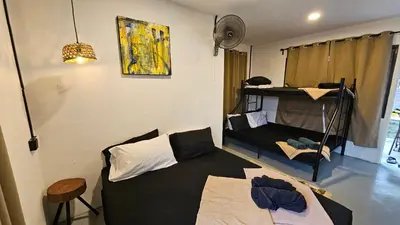 a room with a bed and a couch in it at Batu Puteh Chalet by the River, Pool, WIFI