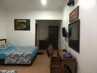 a bedroom with a bed and a television and a table at Villa Desa Permai in Sungai Besar