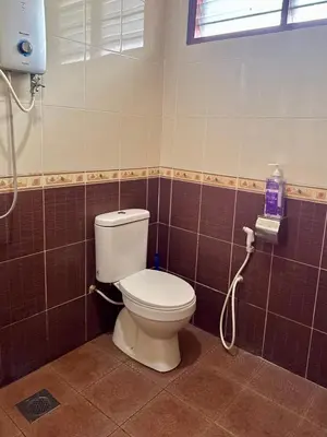 a bathroom with a toilet and a shower at Villa Desa Permai in Sungai Besar