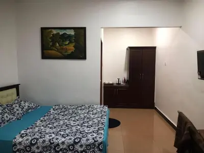 a bedroom with a bed and a door to a cabinet at Villa Desa Permai in Sungai Besar