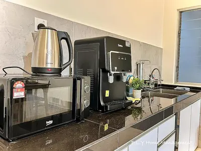 a kitchen with a microwave and a coffee maker on a counter at Kampung Paloh Residence Ipoh Town in Ipoh