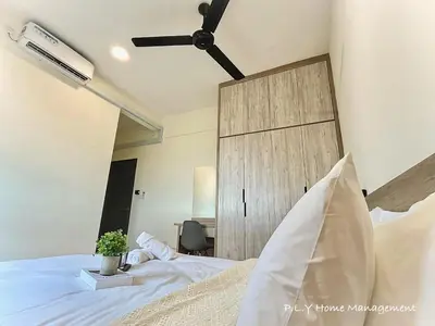 a bedroom with a white bed with a wooden door at Kampung Paloh Residence Ipoh Town in Ipoh