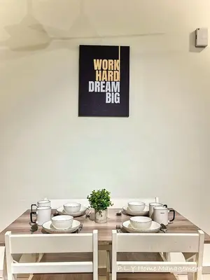 a dining room table with white dishes on it at Kampung Paloh Residence Ipoh Town in Ipoh