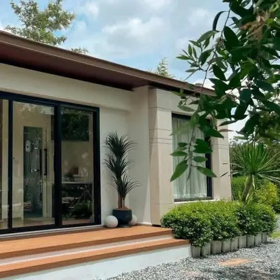 a house with a potted plant on the front porch at Desa Permai in Sungai Besar