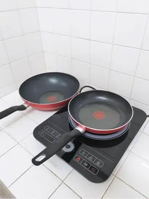 two pans sitting on top of a stove at Ipoh Tambun Field - Landed House 9px - 3R2B in Ipoh