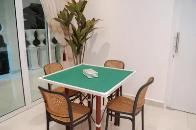 a dining room table with chairs and a green top at Coconut Bay beach Villa seaview karaoke 20pax in Tanjung Bungah