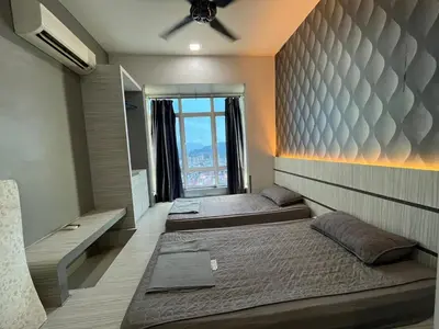 two beds in a room with a large window at Majestic Condo Top Floor 2room Smart TV & WiFi in Ipoh