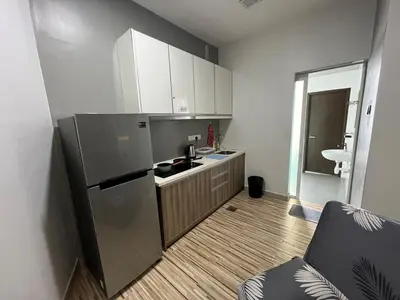 a small kitchen with a refrigerator and a sink at Majestic Condo Top Floor 2room Smart TV & WiFi in Ipoh