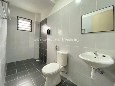 a white bathroom with a toilet and a sink at Seri Centuarea Homestay, Seri Iskandar in Seri Iskandar