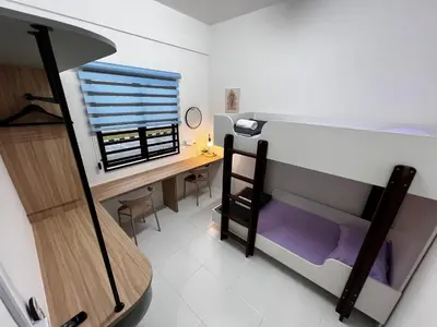 a small room with a desk and a bunk bed at Homestay Kesidang in Seri Iskandar
