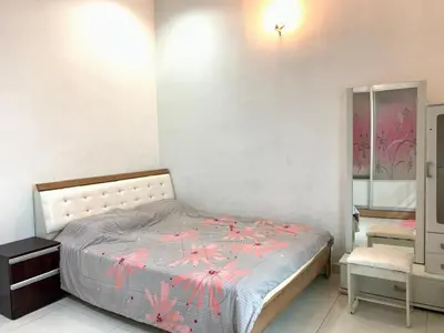 a bedroom with a bed with pink flowers on it at Taiping Nest Homestay 3BR, 7Pax, WiFi, Private Parking, Comfy in Taiping