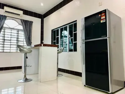 a large refrigerator in a room with a window at Taiping Nest Homestay 3BR, 7Pax, WiFi, Private Parking, Comfy in Taiping