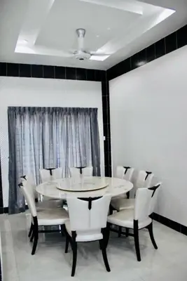 a dining room with a table and white chairs at Taiping Nest Homestay 3BR, 7Pax, WiFi, Private Parking, Comfy in Taiping