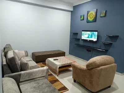 a living room with two chairs and a tv at QAUSAR HOMESTAY KERLING Hulu Selangor in Kerling