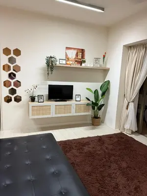 a living room with a tv on a wall at Azure Haven - Seaview Resort Home, By the Sea Batu Ferringhi in Batu Ferringhi