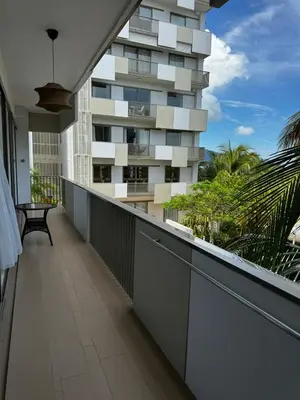 an empty balcony with a building in the background at Azure Haven - Seaview Resort Home, By the Sea Batu Ferringhi in Batu Ferringhi