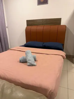 a bed with a stuffed animal sitting on it at Studio Unit Trefoil Setia Alam in Gua Sai