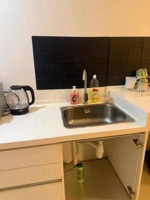 a kitchen counter with a stainless steel sink at Studio Unit Trefoil Setia Alam in Gua Sai