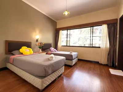 a bedroom with two beds with stuffed animals on them at Equatorial Hill Resort, Mountain view In Cameron Highlands in Brinchang