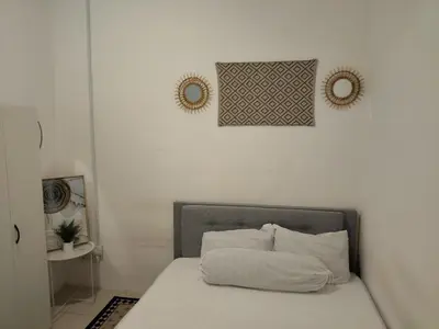 a bedroom with a bed with a pillow on it at D' Ara SZ Homestay in Kubang Semang