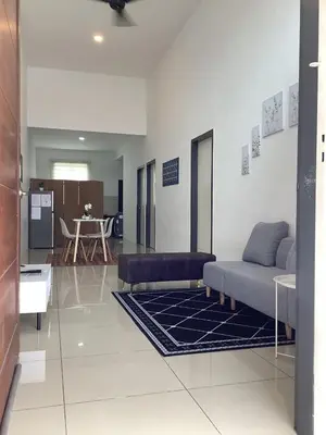 a living room with a couch and a table at D' Ara SZ Homestay in Kubang Semang