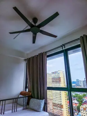 a ceiling fan in a room with a large window at Spacious Luxury Home 3BR 2BA 14pax in George Town