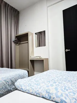 a hotel room with two beds and a closet at High Floor sea view 12 pax 3BR luxury suites b29 in Jelutong