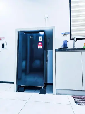 a blue refrigerator in a kitchen next to a counter at High Floor sea view 12 pax 3BR luxury suites b29 in Jelutong