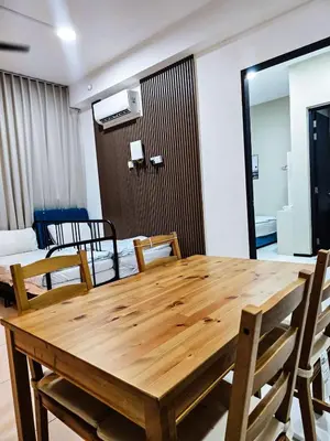 a wooden table and chairs in a room at High Floor sea view 12 pax 3BR luxury suites b29 in Jelutong