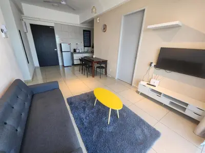 a living room with a couch and a table and a tv at Praicon Tower Hotel Large Suite 3BR - Butterworth in Butterworth