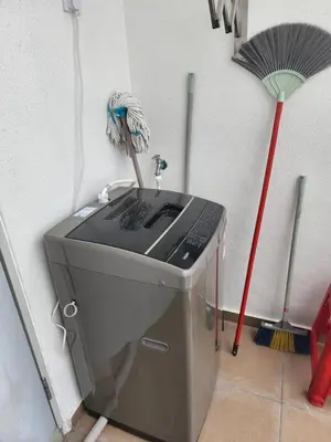a washing machine in a corner with a broom at Praicon Tower Hotel Large Suite 3BR - Butterworth in Butterworth