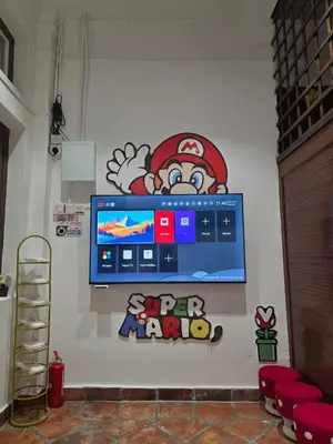 a wall with a tv with a super mario game on it at New ! 6 Pax Super Mario Georgetown Heritage Pre-war House 2 Bedroom in George Town