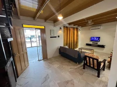 a living room with a couch and a tv at Menglembu Ipoh Homestay M21 Smart TV & WiFi ready in Ipoh