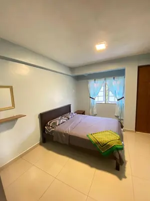 a bedroom with a bed in a room with a window at Rayyan'Homestay DESA in Tanah Rata