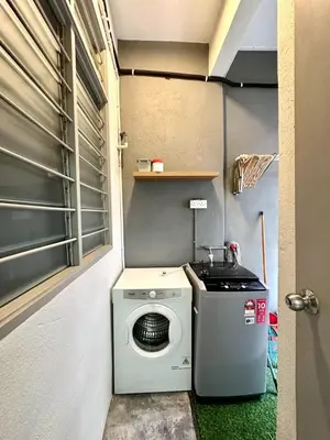 a washer and dryer in a small room at Charming 4BR Family House Quite Area & Cozy in Simpang Ampat