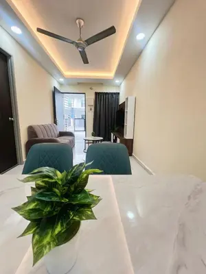 a dining room with a table and a ceiling fan at Homestay Sungai Petani 3 Bedroom in Taman Mutiara Bandar Puteri Jaya by D'Aleena Homes in Sungai Petani