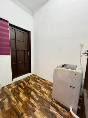 a room with a wood floor and a door at Homestay Sungai Petani 3 Bedroom in Taman Mutiara Bandar Puteri Jaya by D'Aleena Homes in Sungai Petani