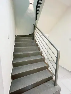 a staircase in a building with a stair case at Homestay Sungai Petani 3 Bedroom in Taman Mutiara Bandar Puteri Jaya by D'Aleena Homes in Sungai Petani