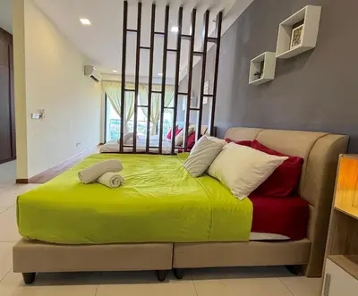 a large bed in a room with a window at Landmark Seaview Cozy Family Suite with Balcony 6 Pax in Tanjong Tokong