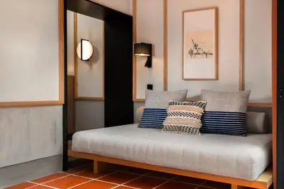 a bed with blue and white pillows on it at Cheong Fatt Tze - The Qing Suites in George Town