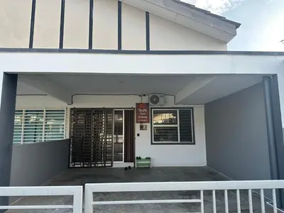 a white building with a gate in front of it at Nady Salam Homestay in Seri Iskandar