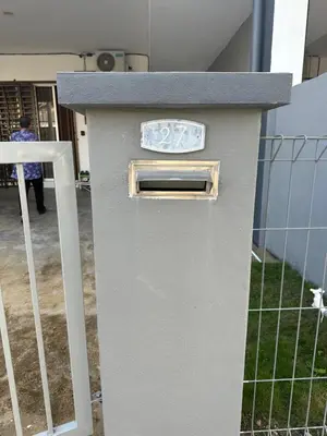 a gray box sitting next to a fence at Nady Salam Homestay in Seri Iskandar