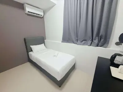 a small room with a white bed and a window at Gather inn in George Town