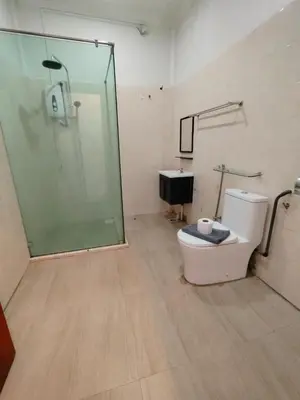 a bathroom with a shower and a toilet and a sink at Pahang Rest House Raub in Raub