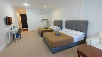 a hotel room with two beds and a television at Pahang Rest House Raub in Raub